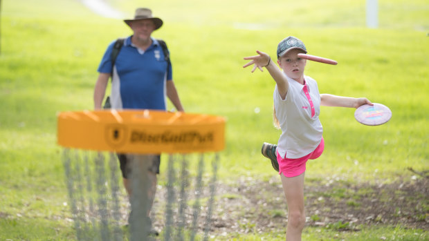 Melbourne Disc Golf Club president Jeff Brunsting and junior competitor Evelyn Heath get their eye in.