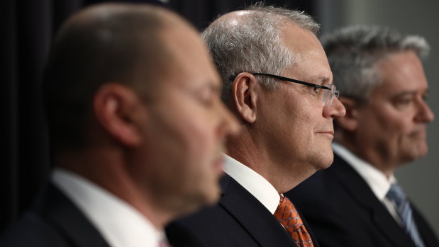 Former prime minister Scott Morrison with former treasurer Josh Frydenberg and former finance minister Mathias Cormann after the then-government’s tax package passed the Senate in 2019.