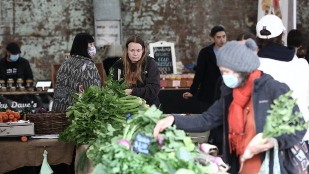 About half of shoppers and stallholders wore face masks at Carriageworks Farmers Markets, which reopened Saturday.