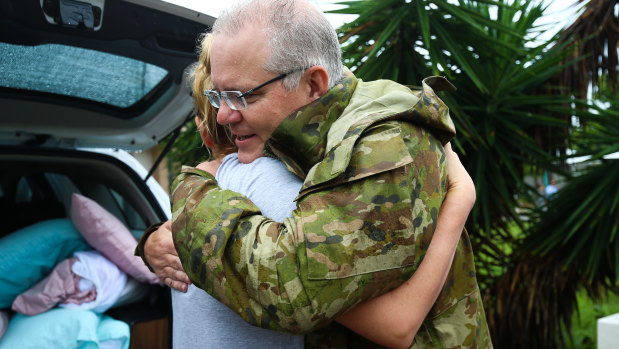 Mr Morrison is seen hugging a Townsville resident.