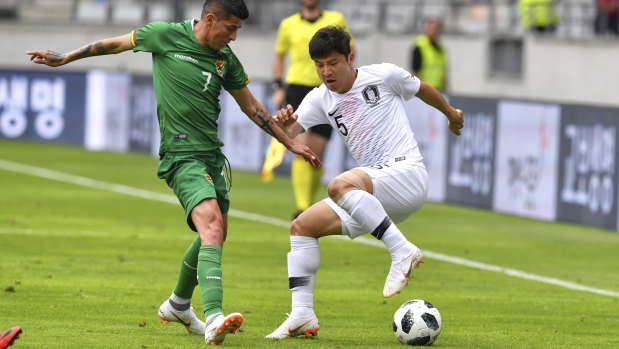 Stalemate: South Korea's Park Joo-ho, right, and Bolivia's Juan Carlos Arce challenge for the ball.