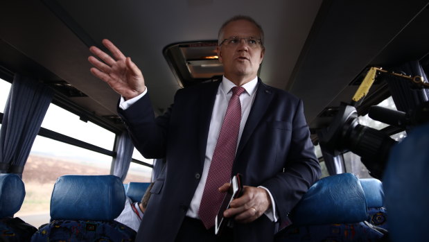 Prime Minister Scott Morrison gets on the media bus after visiting the Premium Fresh carrot farm near Forth, Tasmania.