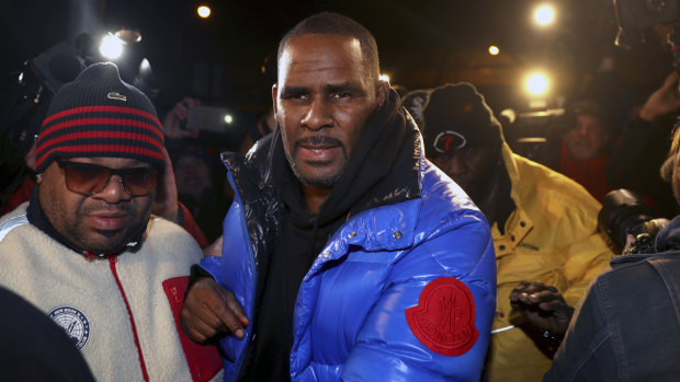 R. Kelly turns himself in at a Chicago police station after being charged with sexual abuse.