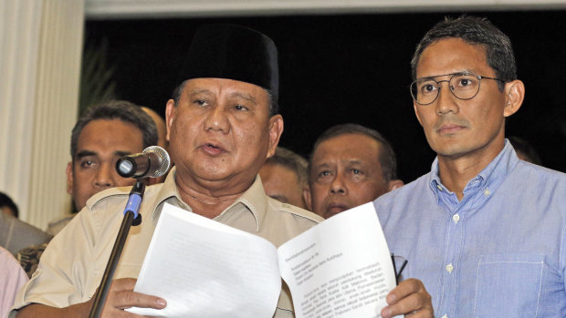 Losing presidential candidate Prabowo Subianto, left, speaks to reporters as his running mate Sandiaga Uno listens during a press conference in Jakarta, Indonesia.
