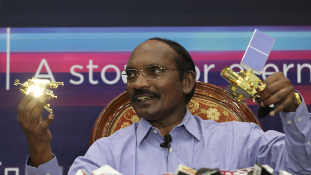 Indian Space Research Organisation chairman Kailasavadivoo Sivan displays a model of Chandrayaan 2 orbiter and rover during a press conference in Bangalore.