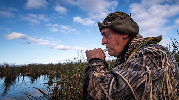 Duck hunter Dave Smeaton using his caller to lure ducks in.