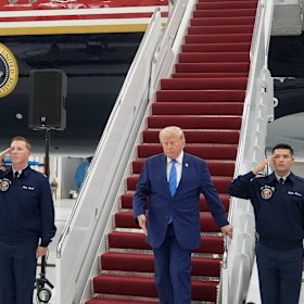 President Donald Trump exits the newly designated Air Force One.