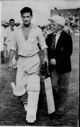 Where it all began: Neil Harvey is greeted by a fan as he leaves the field in his first Test.