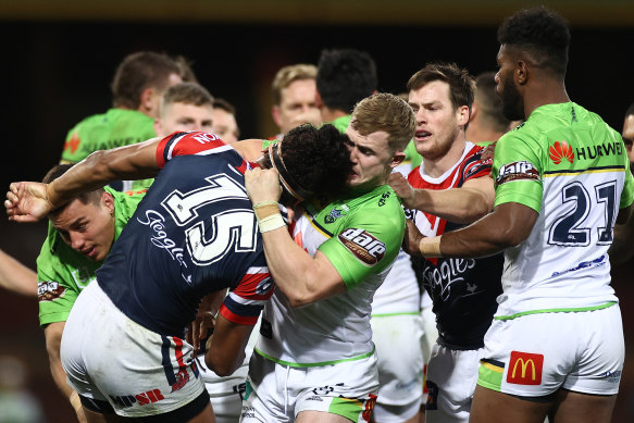 Roosters and Raiders players scuffle during Canberra's win.