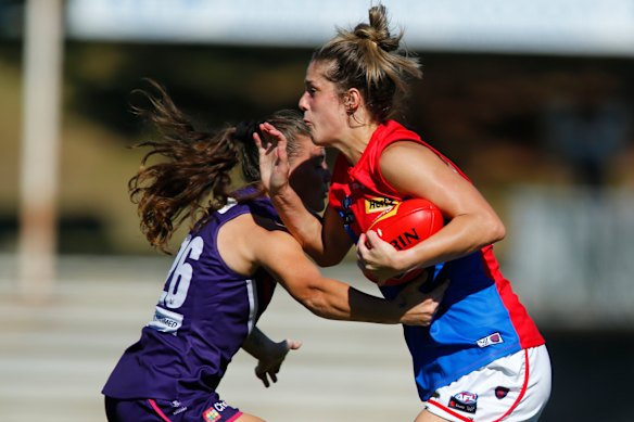 Lauren Pearce, right, fends off a tackle. 