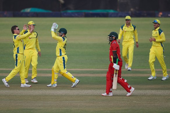 Australia’s bowler Adam Zampa, left, celebrates with teammates after bowling Zimbabwe’s batsman Innocent Kaia.