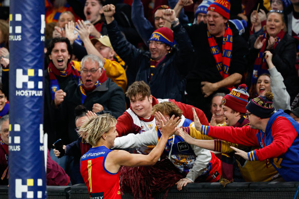 Kai Lohmann of the Lions celebrates a goal with fans.