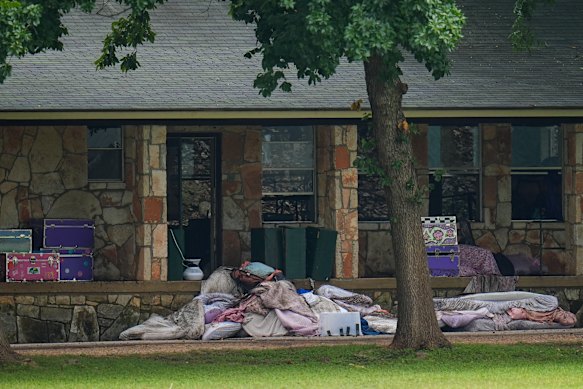 Bedding items are piled up outside sleeping quarters at Camp Mystic after the flood.