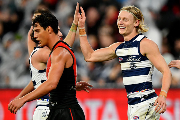 Oliver Dempsey is congratulated by teammates after kicking a goal.