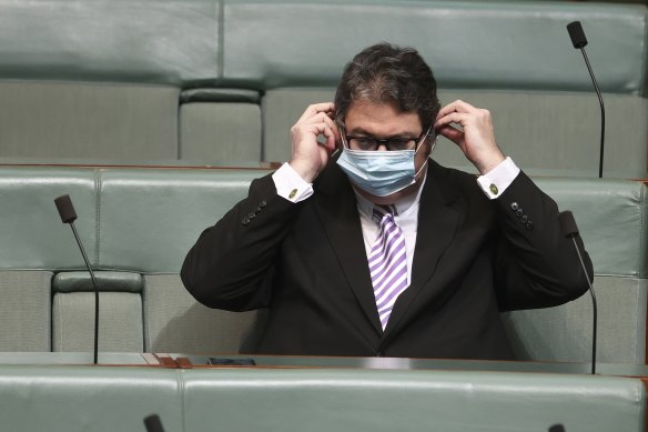 Nationals MP George Christensen removes his mask in order to share his view about how masks don’t work.