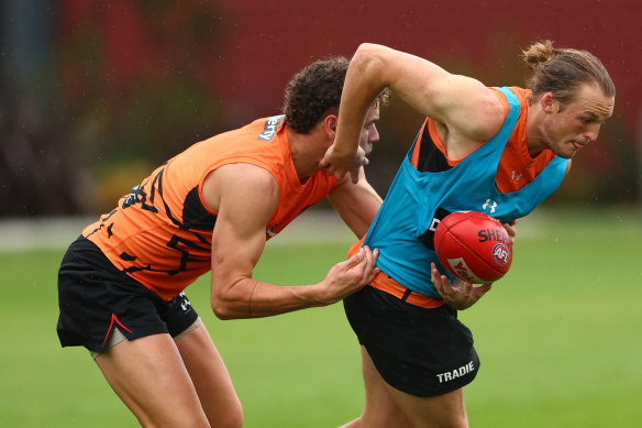 Essendon’s Mason Redman tries to break a tackle on Saturday.