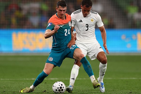 Deni Juric of Australia controls the ball under pressure from Juriën Gaari of Curacao.
