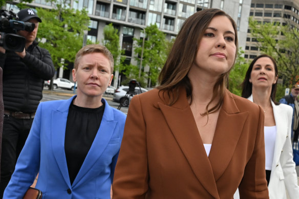 Brittany Higgins (centre) being accompanied to court by ACT Victims of Crime Commissioner Heidi Yates (left) during the trial.