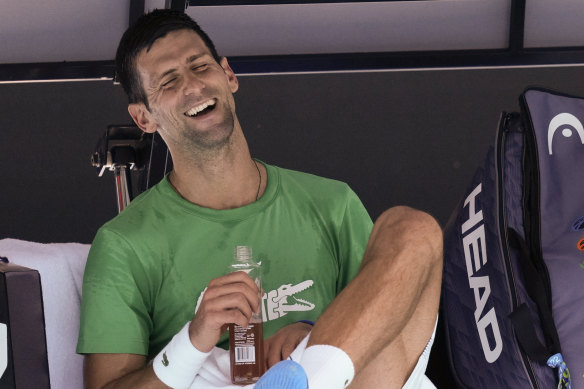 Novak Djokovic shares a laugh during a break on the Rod Laver Arena on Thursday. 
