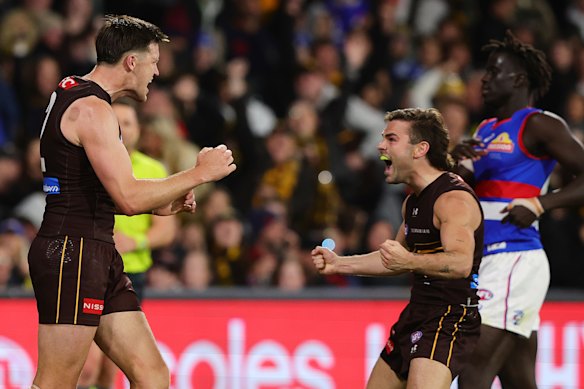The tall and the short of it: Mitch Lewis and Nick Watson celebrate a goal.