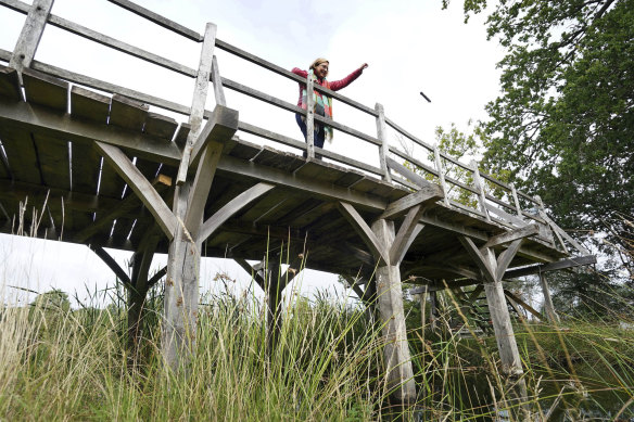 Silke Lohmann of Summers Place Auctions stands on the original Poohsticks Bridge from Ashdown Forest, featured in A.A. Milne’s Winnie the Pooh books.