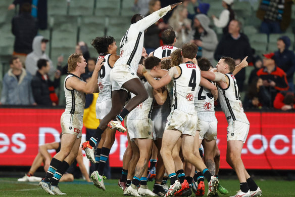 That joyous feeling: Port Adelaide players converge on the match-winner.