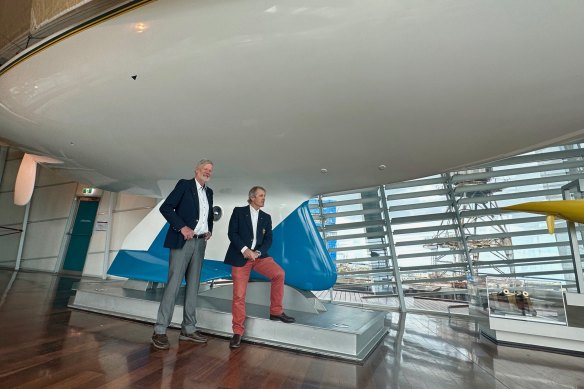 John Longley (left) and Skip Lissiman (right) in front of the Ben Lexcen-designed Australia II at the WA Maritime Museum in Fremantle.