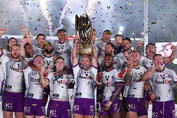 The Storm celebrate with the premiership trophy at ANZ Stadium.