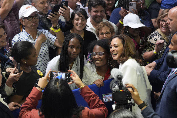 Vice President Kamala Harris poses for photos with supporters at a campaign rally in Savannah, Georgia.