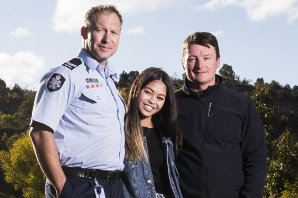 First responders ACT Policing search and rescue coordinator Lachlan Ryan and former ACT Parks area manager Tim Chaseling with Kathleen Bautista at the site of the crash.