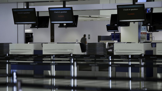 Closed check-in counters in the departure terminal at Sydney international airport.
