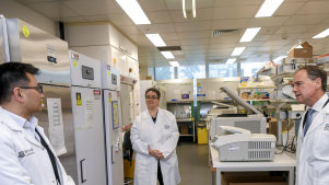 The Minister for Health, Greg Hunt, Associate Professor Mireille Lahoud and Professor Allen Cheng at the Monash Biomedicine Discovery Institute on May 20 last year.