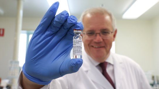 Prime Minister Scott Morrison holding up the AstraZeneca COVID-19 vaccine at the TGA headquarters on Wednesday.