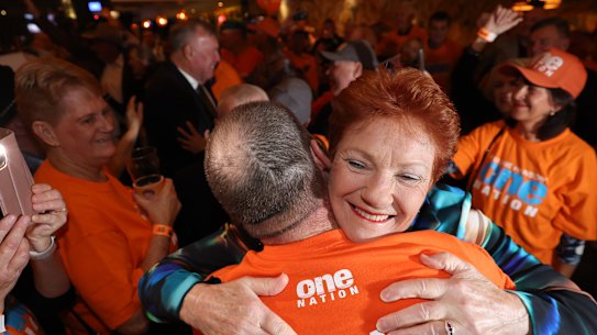 Pauline Hanson embraces a supporter at the One Nation HQ party in Albury on Saturday.