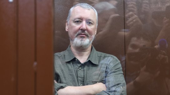 Russian nationalist Kremlin critic and former military commander Igor Girkin, also known as Igor Strelkov, who is charged with inciting extremist activity, sits behind a glass wall of an enclosure for defendants before a court hearing in Moscow.