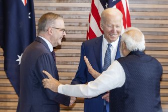 Albanese, Biden and Modi laugh during a group photo at a meeting of ATV leaders.