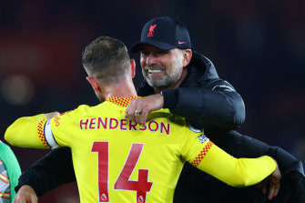 Liverpool manager Juergen Klopp and captain Jordan Henderson celebrate the Reds’ 2-1 win over Southampton.