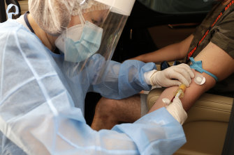 A health worker at a drive-through COVID-19 testing facility in Manila.