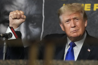 Donald Trump salutes fans before providing commentary at a Las Vegas boxing match between former heavyweight champ Evander Holyfield and former MMA star Vitor Belfort on the 20th anniversary of the September 11 attacks. 