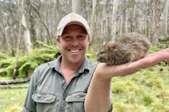 President Tim Faulkner with a broad-toothed rat. 