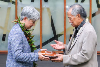 Foreign Minister Penny Wong exchanges gifts with Henry Puna, secretary-general of the Pacific Islands Forum, in Fiji this week.