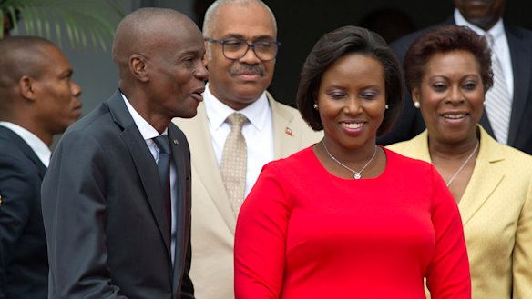 First lady Martine Moise, pictured in red, was also shot in the attack but survived. 