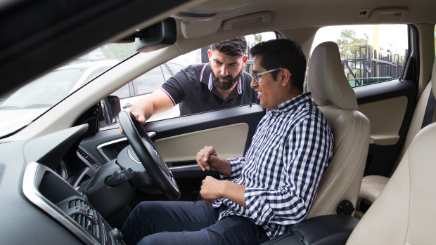 Customer Miguel Mendoza getting instructions for a test drive from ANS Car Sales dealer Bill Assaad.