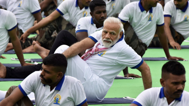 Indian Prime Minister Narendra Modi gets into a twist in Ranchi on Friday.