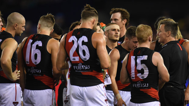 Bombers coach John Worsfold addresses his players during their match against the Bulldogs at Etihad Stadium.