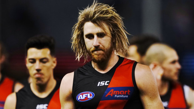 Dyson Heppell leads the Bombers from the field after their abysmal loss to the Western Bulldogs.