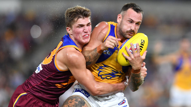 Fast and furious: West Coast's Chris Masten gets wrapped up by Zac Bailey of Brisbane.