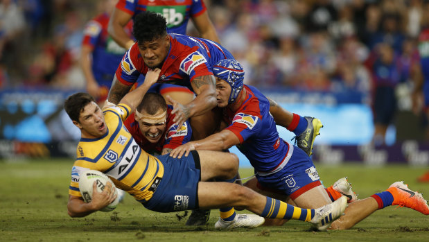Up in the air: Mitchell Moses is brought down against the Knights on Sunday. 