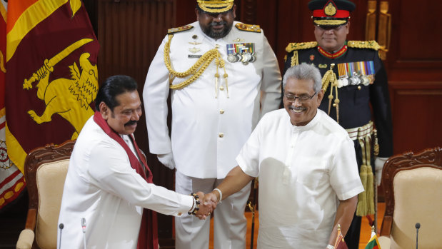 Sri Lanka's President Gotabaya Rajapaksa, right, greets his brother Mahinda after appointing him as Prime Minister on Thursday.