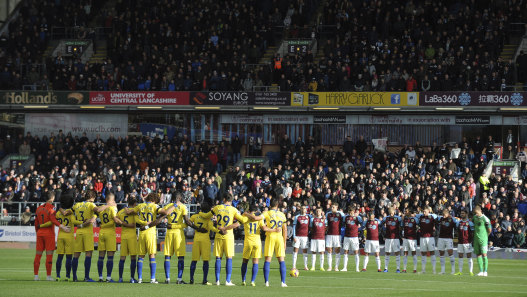 The Burnley and Chelsea teams take part in a moment of silence on Sunday following the helicopter crash at Leicester City the night before.